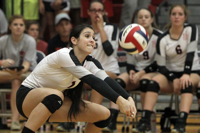 Coppell Cowgirls outside hitter Cathryn Cheek (1) makes a dig against the McKinney Boyd Lady...