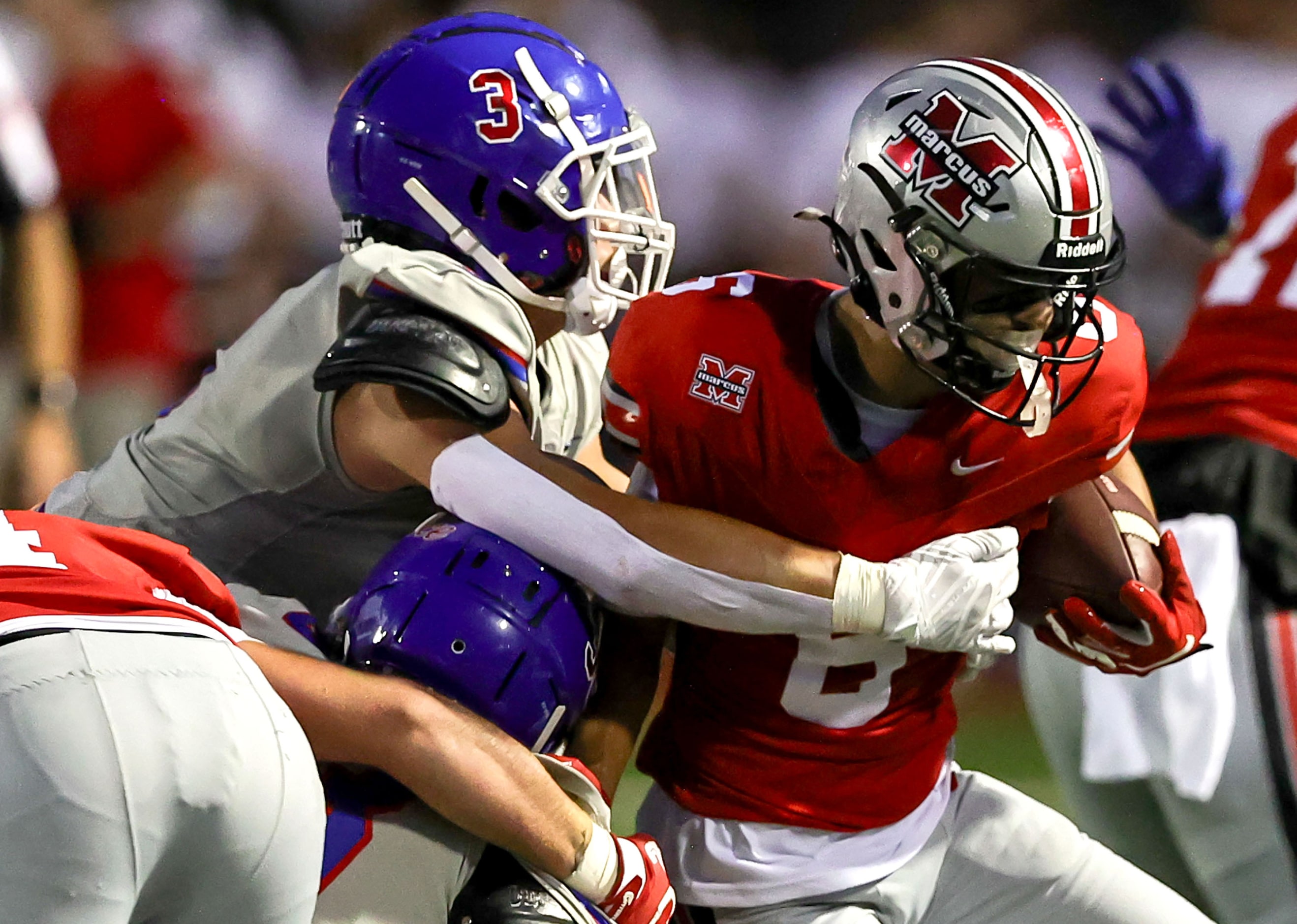 Flower Mound Marcus wide receiver Rhett Garza (6) tries to break a tackle from Richardson...