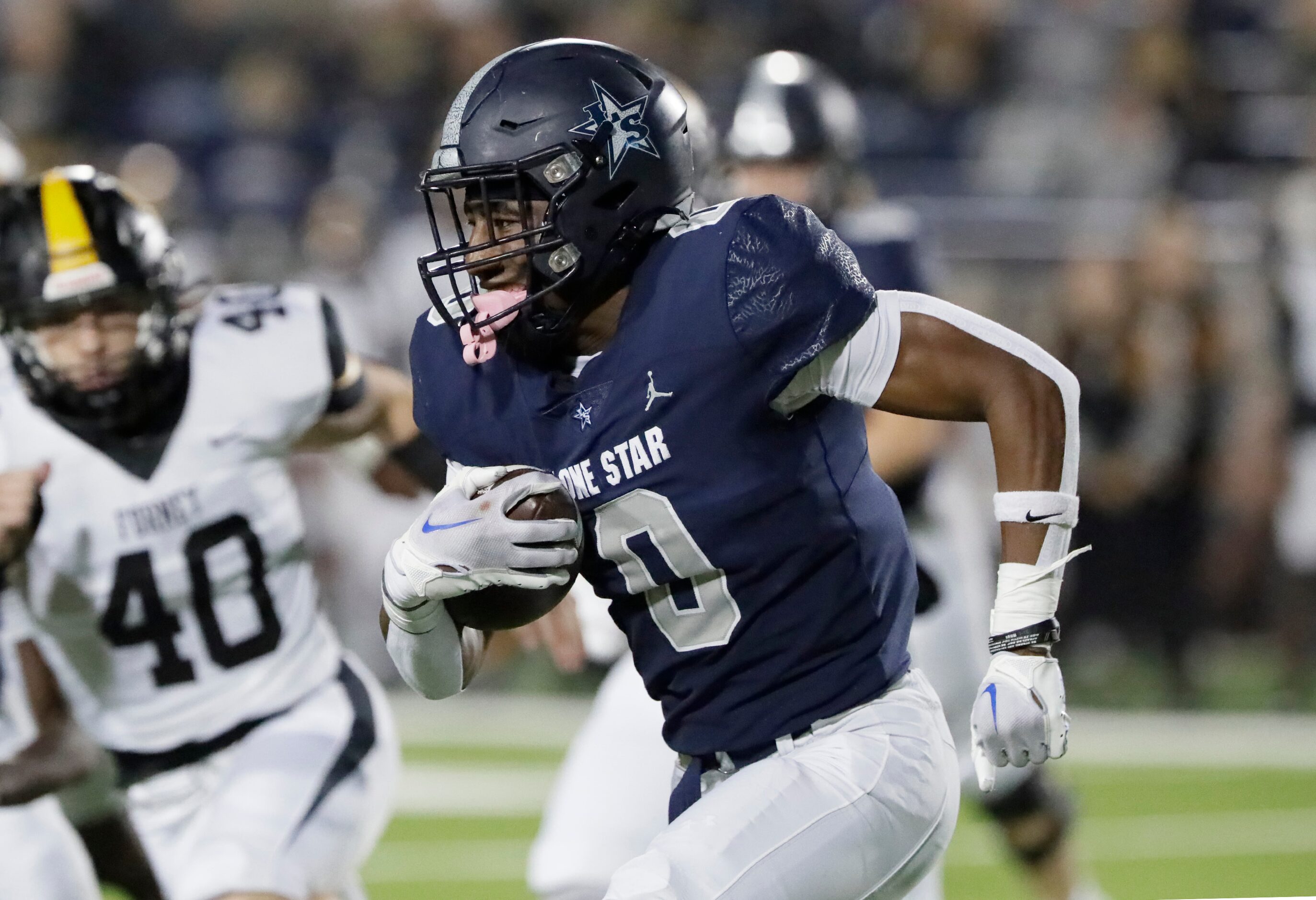 Lone Star High School running back Davian Groce (0) carries the football during the first...