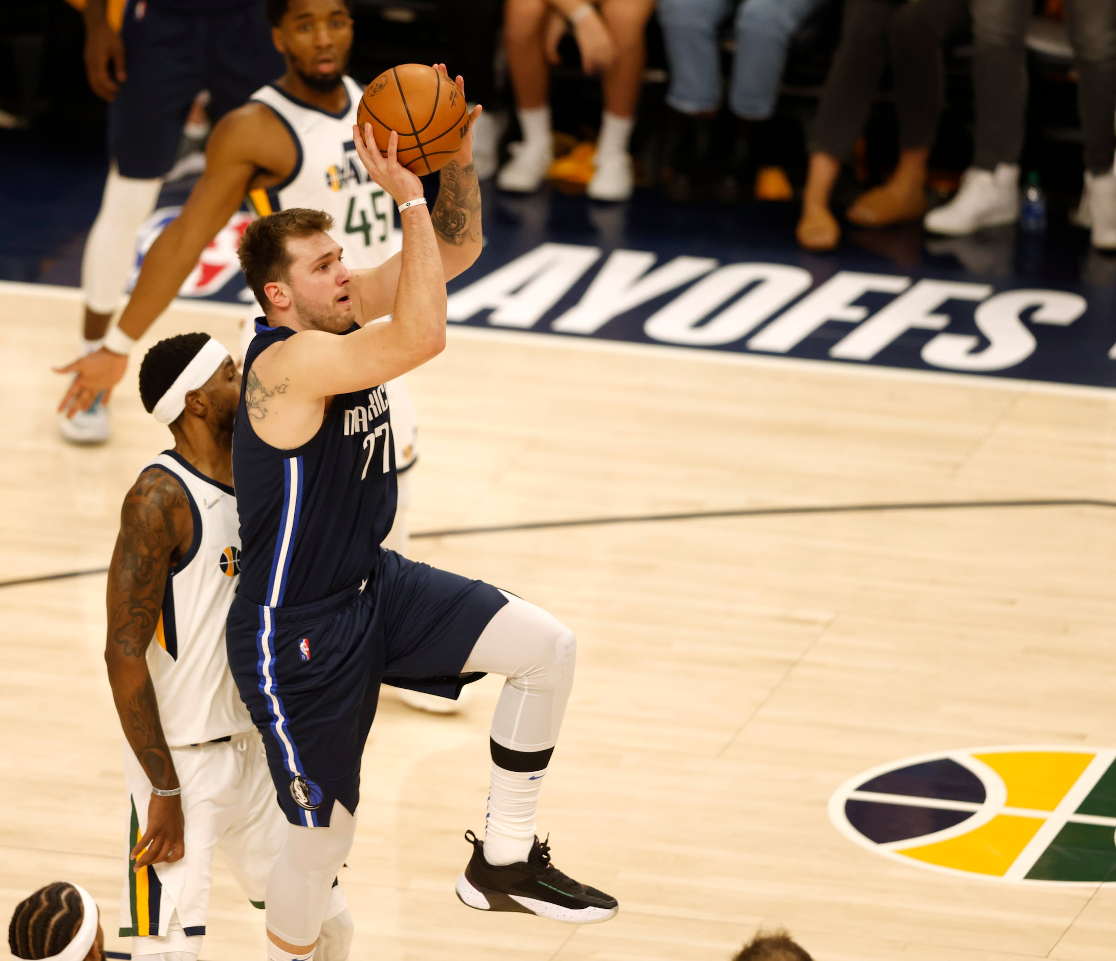 Dallas Mavericks guard Luka Doncic (77) attempts a shot at the end of the half as he is...