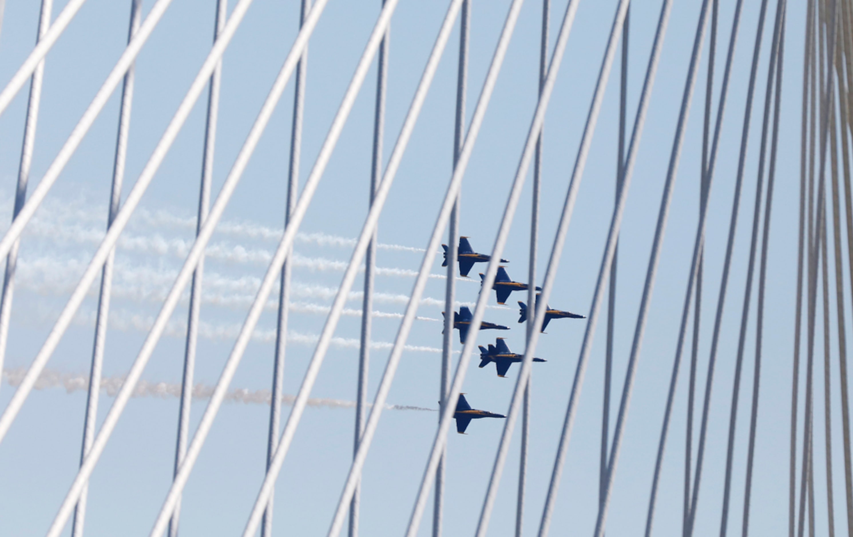 The U.S. Navy Blue Angels, shot through The Margaret Hunt Hill Bridge, fly over the Dallas...