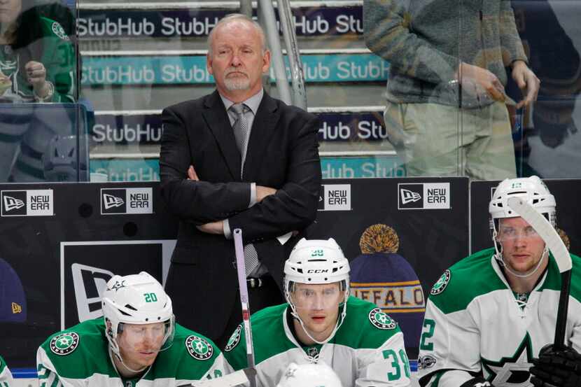 Dallas Stars coach Lindy Ruff looks on during the second period of an NHL hockey game...