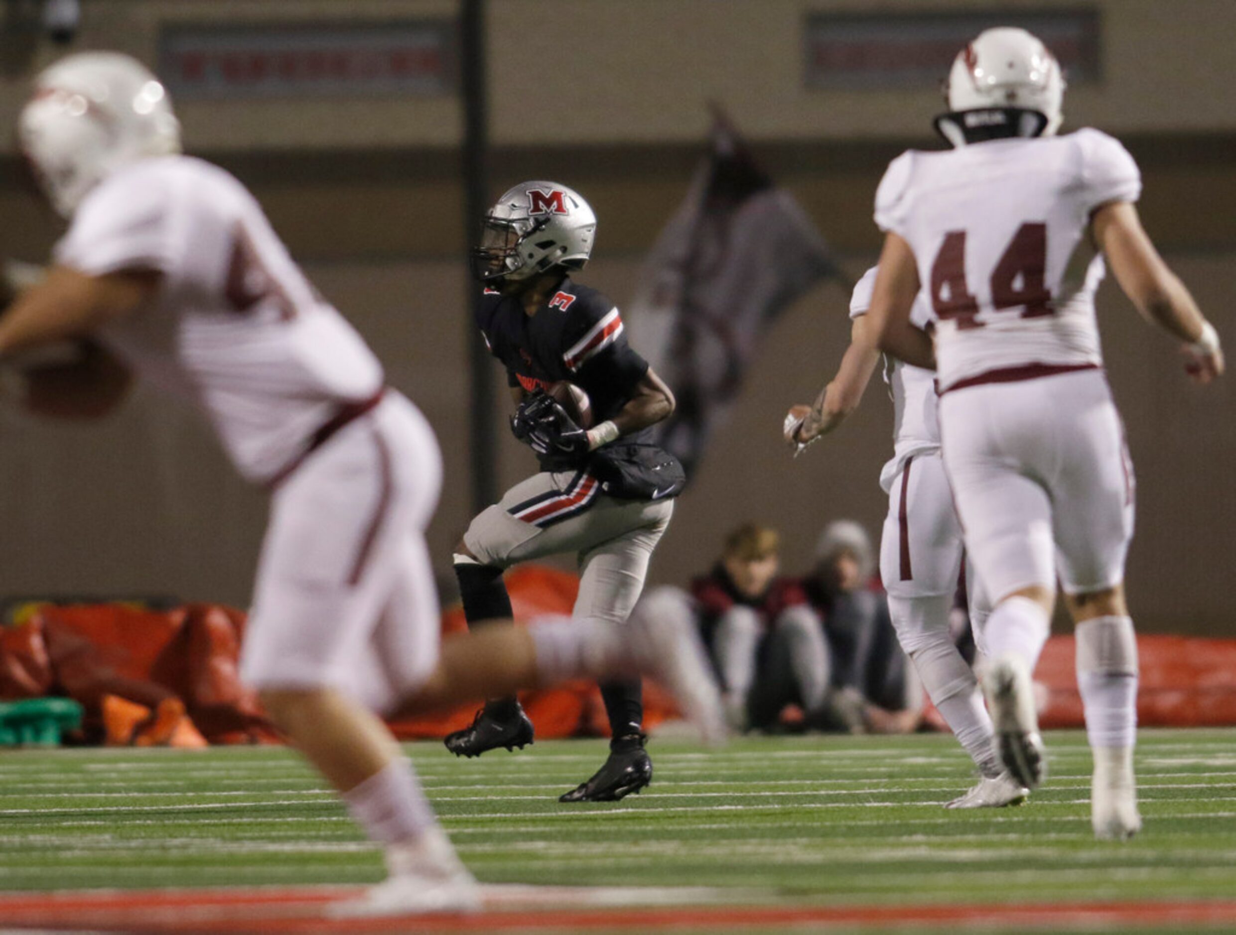 Flower Mound Marcus receiver Jaden Robinson (3) splits Keller Central defenders as he pulls...