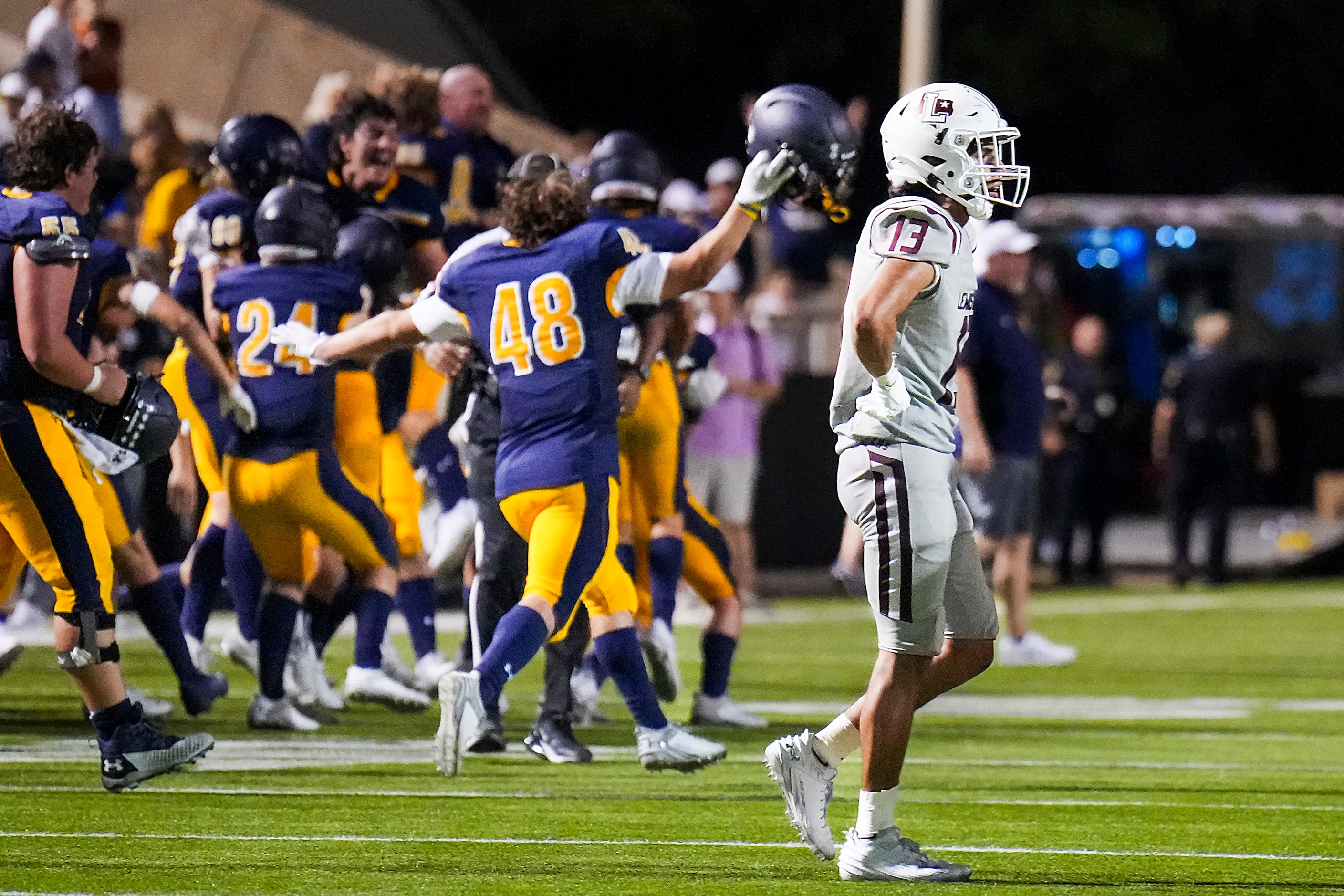 Lewisville wide receiver JJ Gonzales (13) leaves the field as Highland Park players...