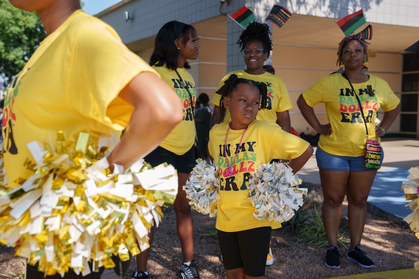 Members of the dance group "Dallas Dollz" prepare to walk in the parade during a Juneteenth...