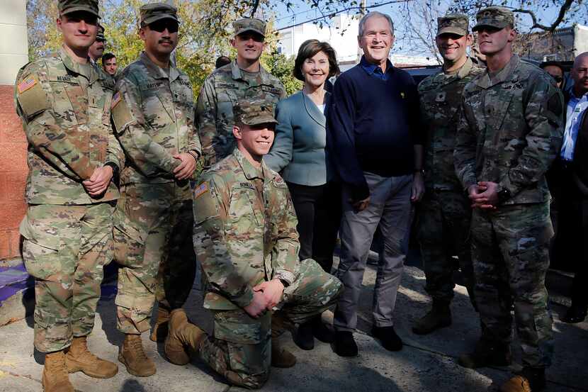 Former President George W. Bush and former first lady Laura Bush joined serviceman for a...