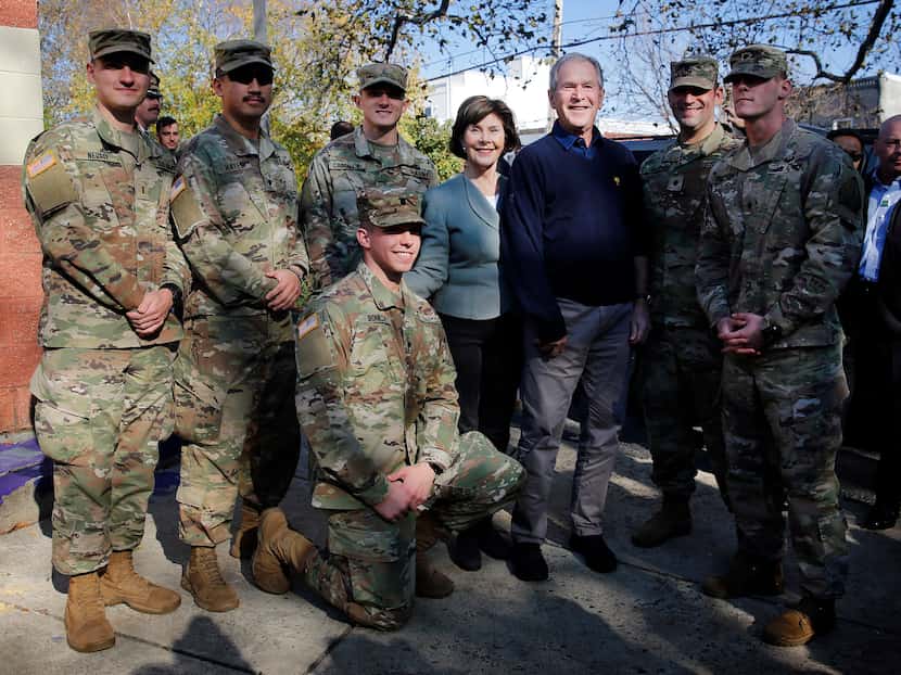 Former President George W. Bush and former first lady Laura Bush joined serviceman for a...