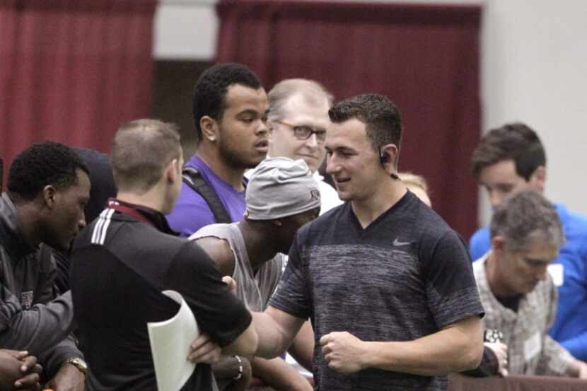 Texas A&M quarterback Johnny Manziel walks into the McFerrin Athletic Center for pro day for...