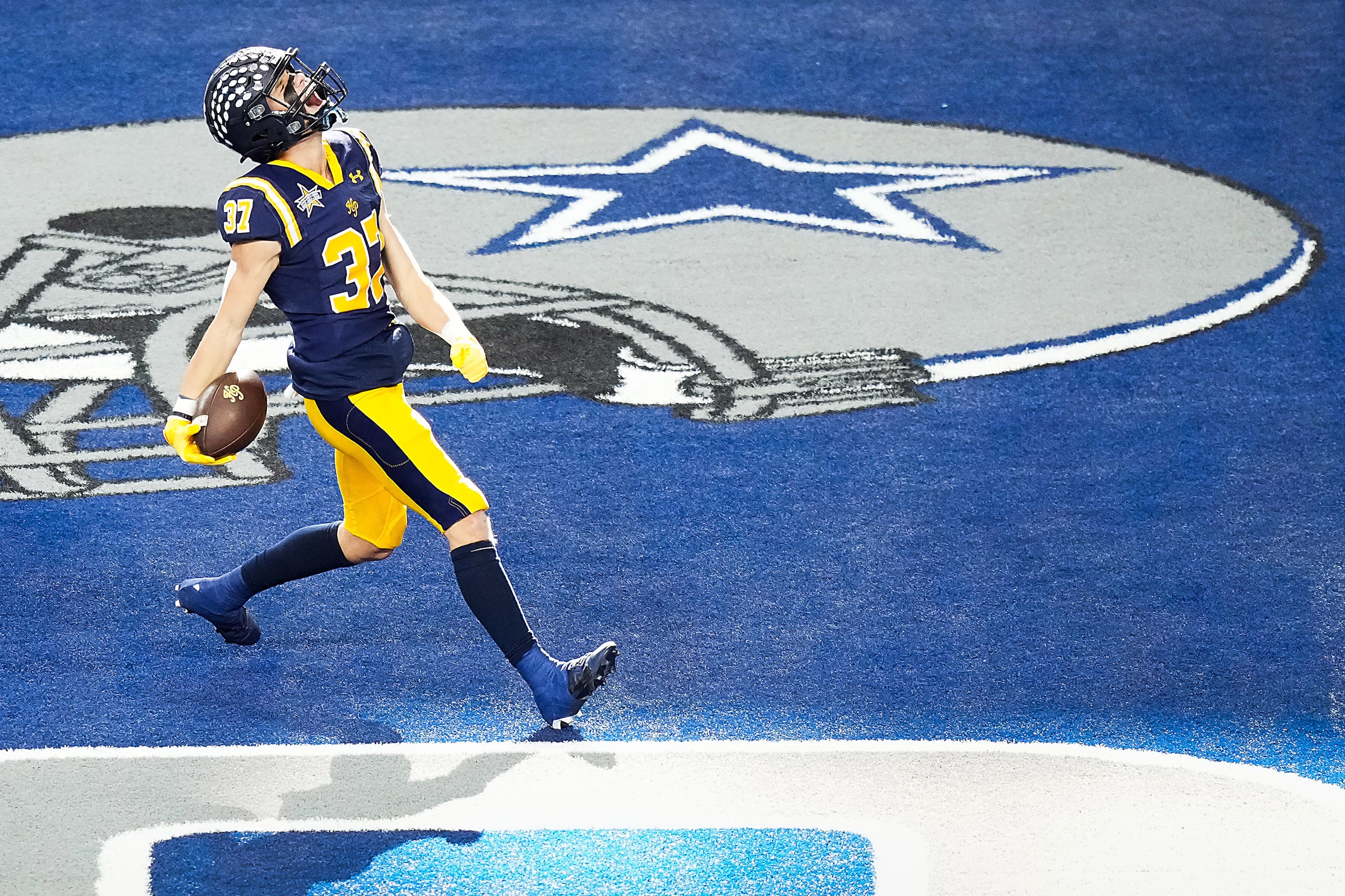 Highland Park's Cannon Bozman celebrates as he scores on a 49-yard touchdown pass during the...