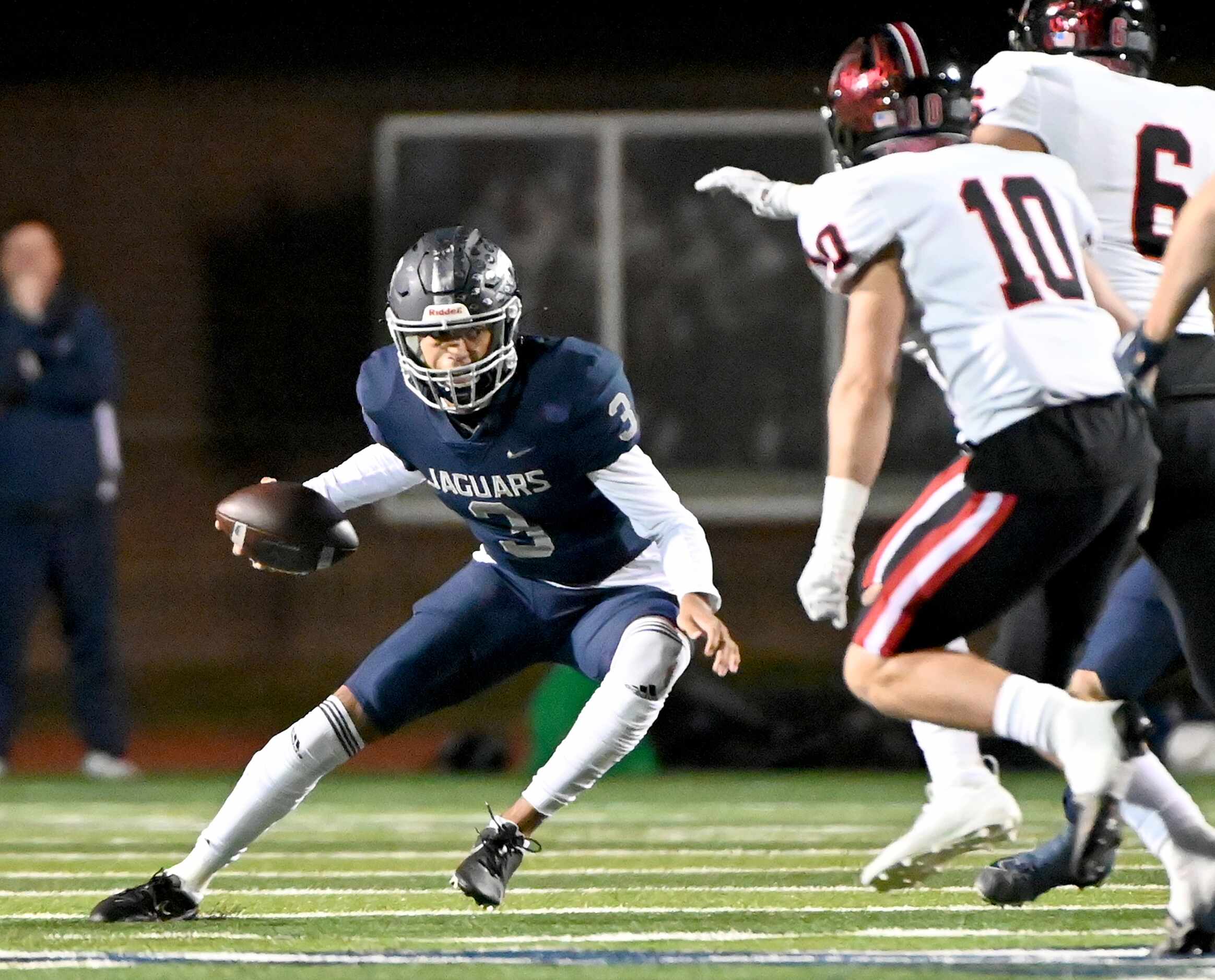 Flower Mound quarterback Nick Evers (3) looks for running room around Coppell's Cooper...