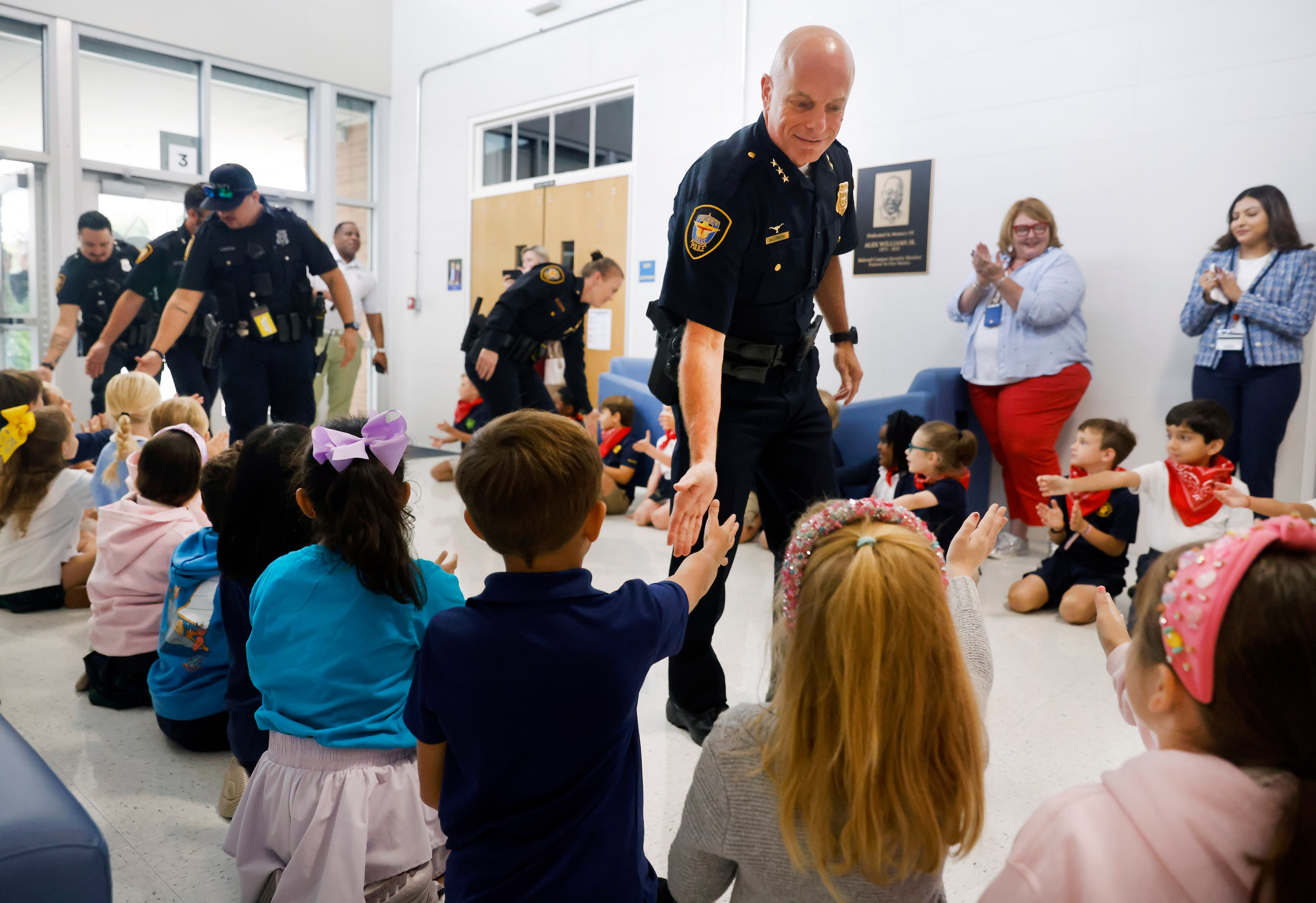 Fort Worth Police Assistant Chief Robert Alldredge and his officers slap hands with  second...