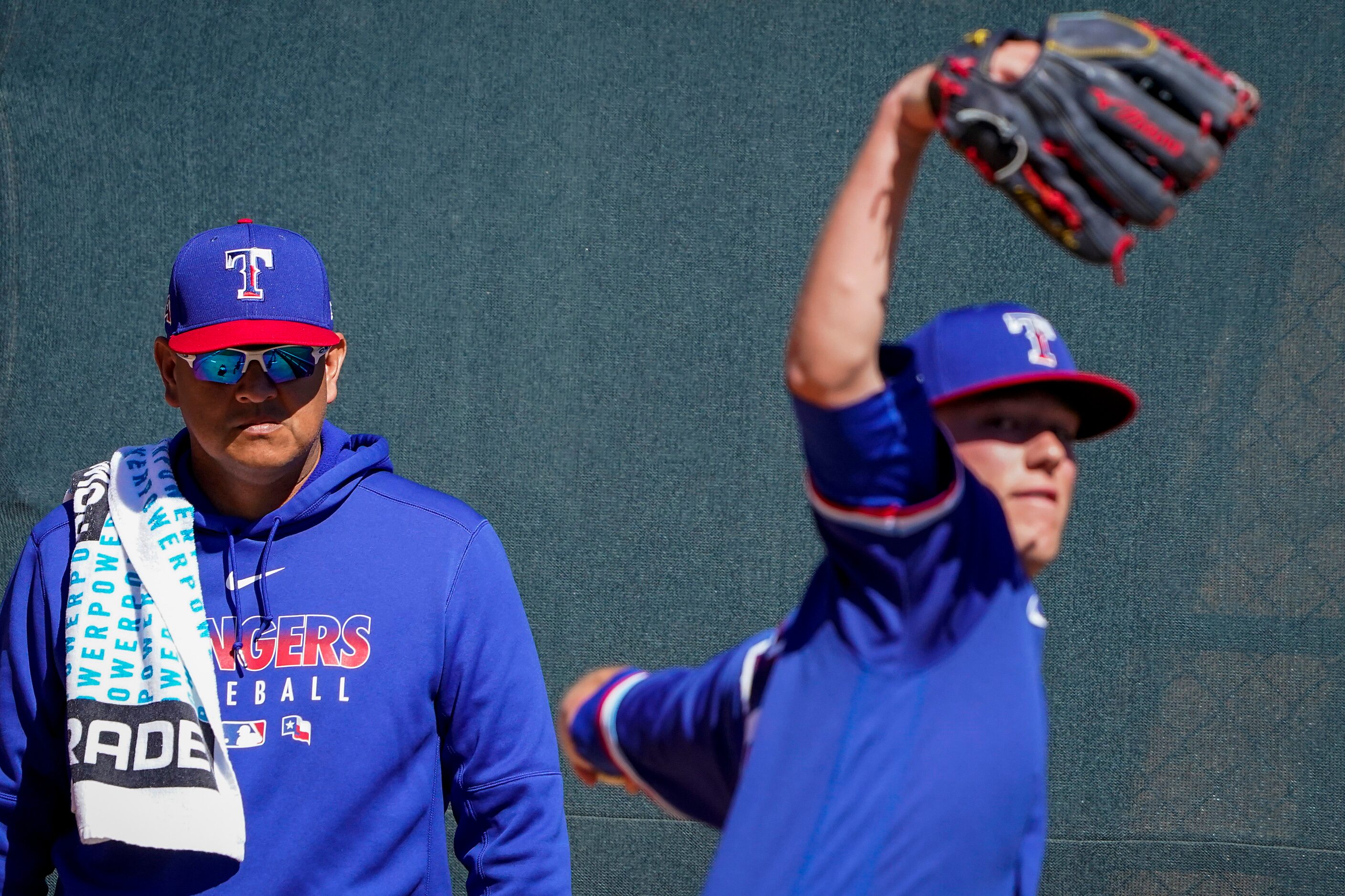 Texas Rangers pitching coach Julio Rangel watches pitcher Kolby Allard warm up in the...