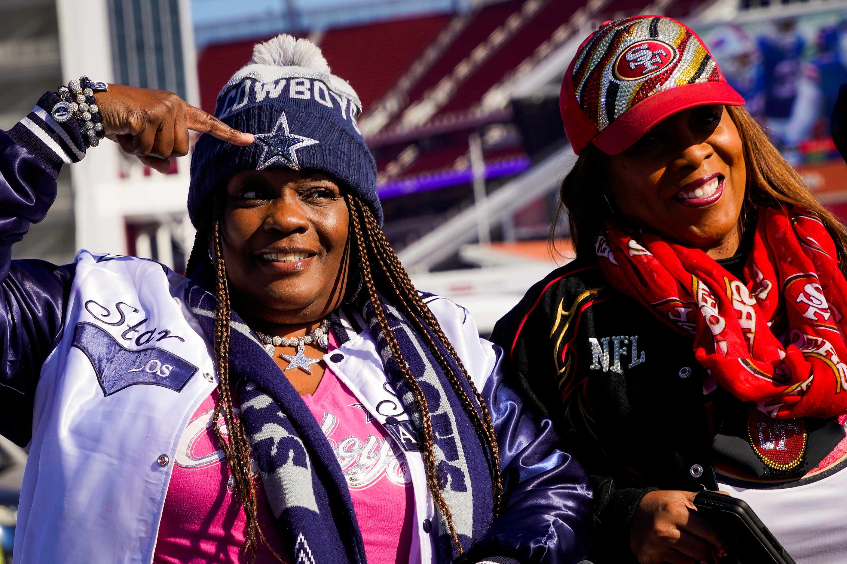 Dallas Cowboys fan Danita Davenport of Loas Angeles points to the star on her cap while...