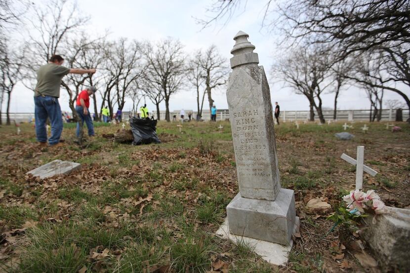 Volunteers work to clean up Shelton's Bear Creek Cemetery in Irving on Saturday, March 10,...