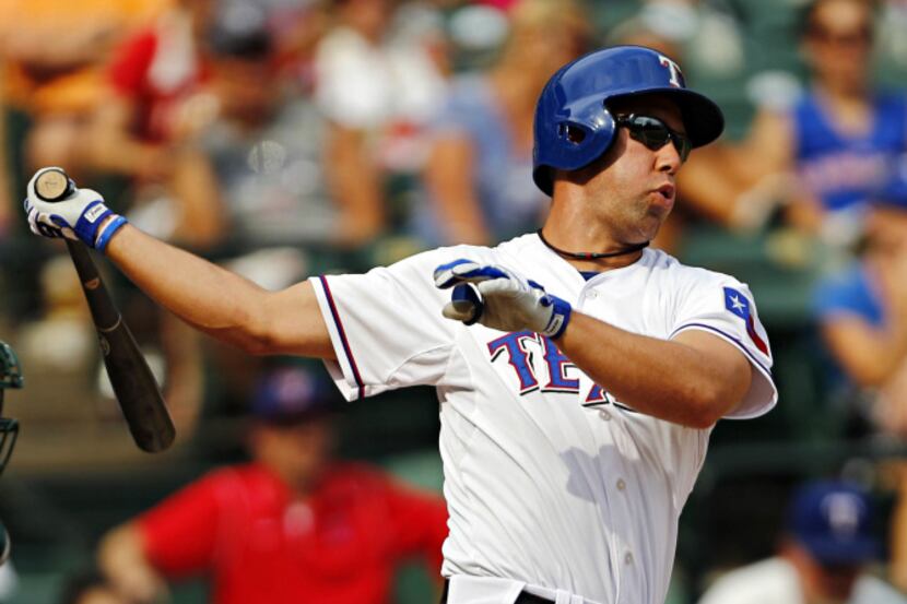 Texas Rangers left fielder David Murphy can't connect with a pitch as he pinch hits during...