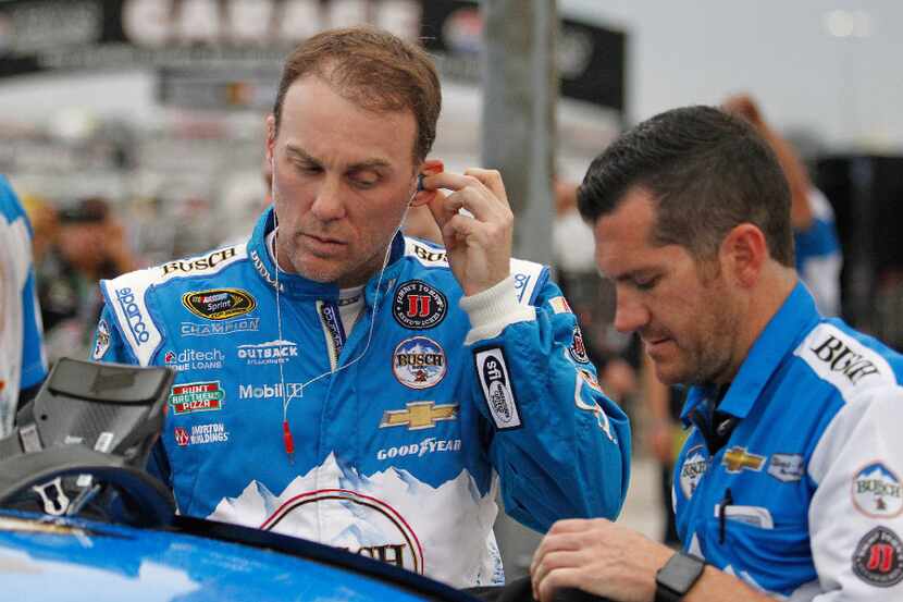 Kevin Harvick puts his radio earpieces in before qualifying for Sunday's NASCAR Sprint Cup...
