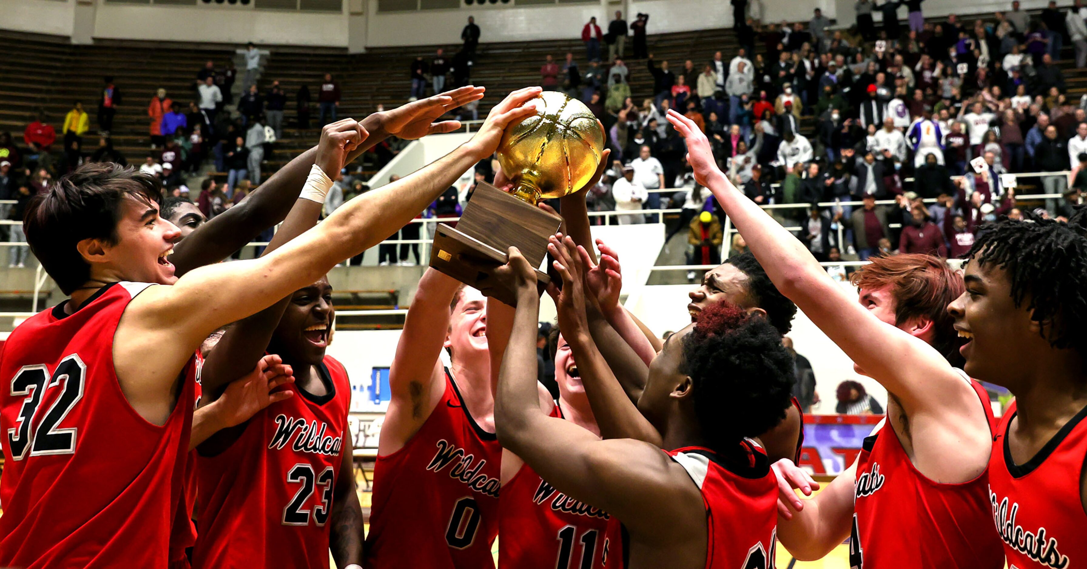 The Lake Highlands Wildcats celebrate their victory over Plano, 58-56 during in he 6A Region...