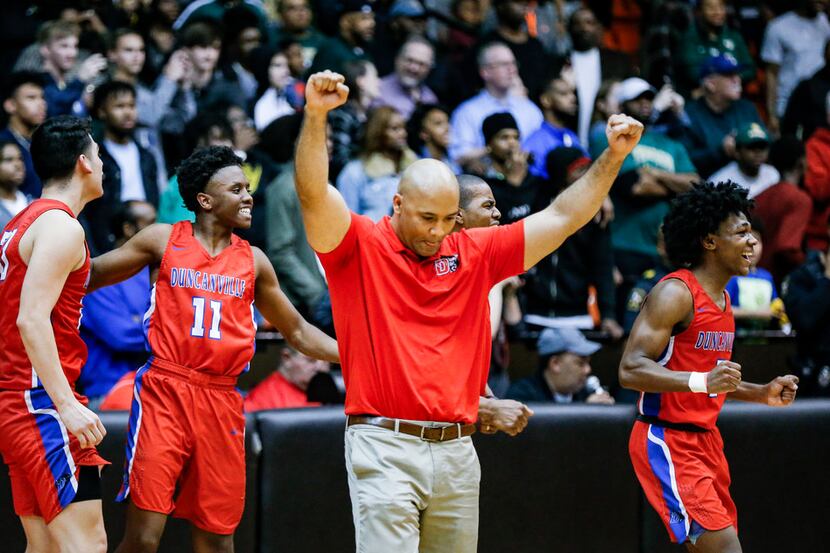 Duncanville head coach David Peavy, third from left, and his team celebrate a 61-60 overtime...