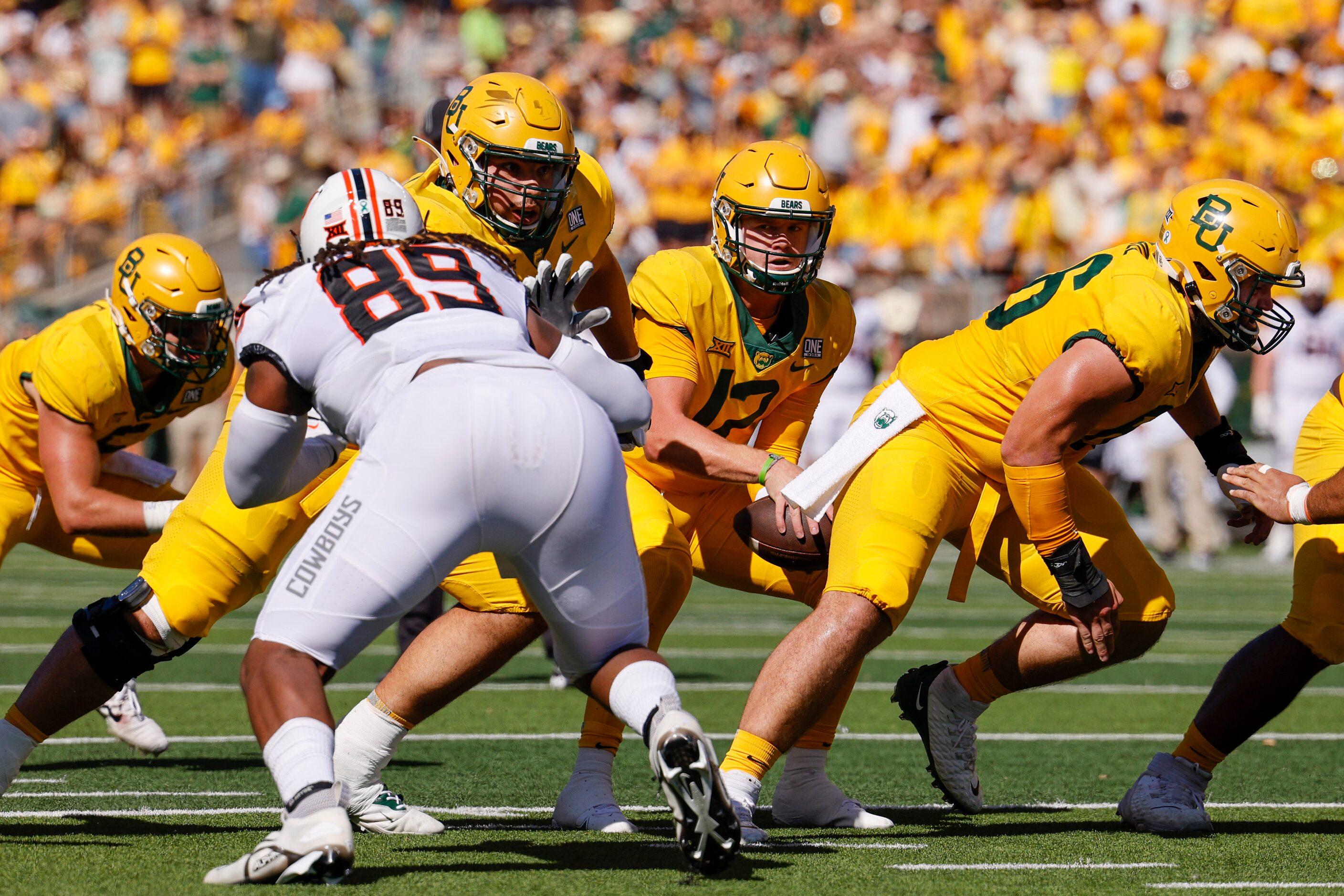 Baylor quarterback Blake Shapen (12) takes the snap from offensive lineman Jacob Gall (66)...