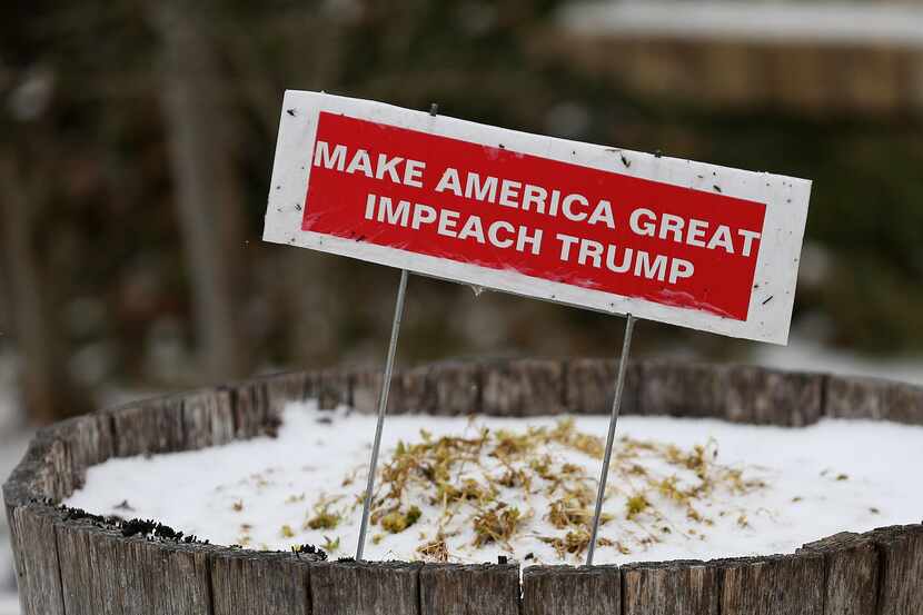 A Garland house displays a sign calling for Donald Trump's impeachment on Jan. 6. (Andy...