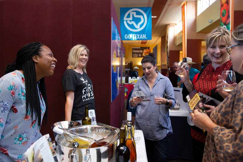 Cheramie Law, left, and Traci Ferguson, middle, of Farmhouse Vineyards promote their wines...