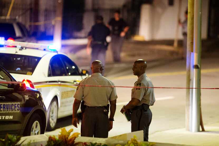 Police stand outside the Emanuel AME Church following a shooting Wednesday, June 17, 2015,...