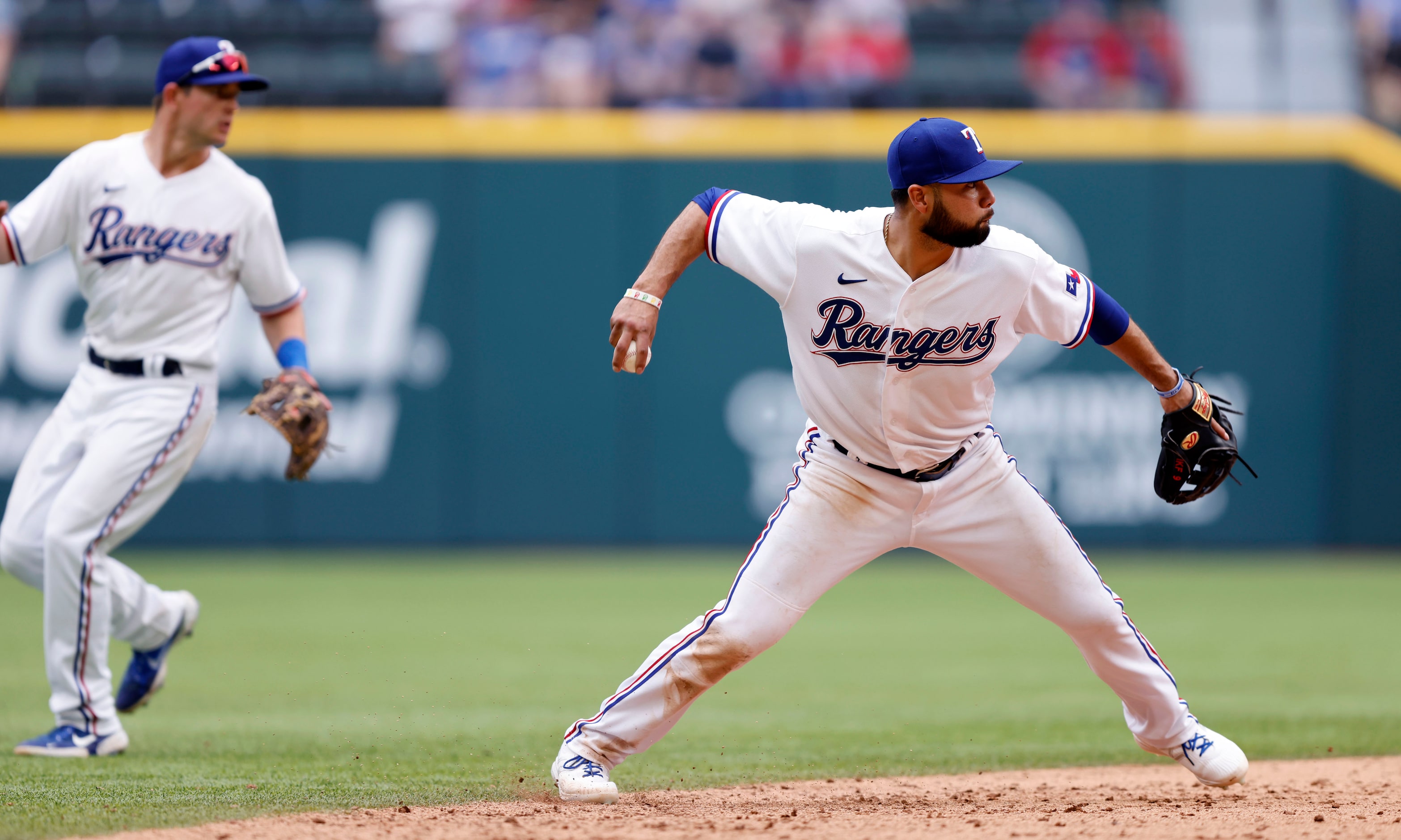 Texas Rangers third baseman Isiah Kiner-Falefa (9) fires the ball to first to get Toronto...