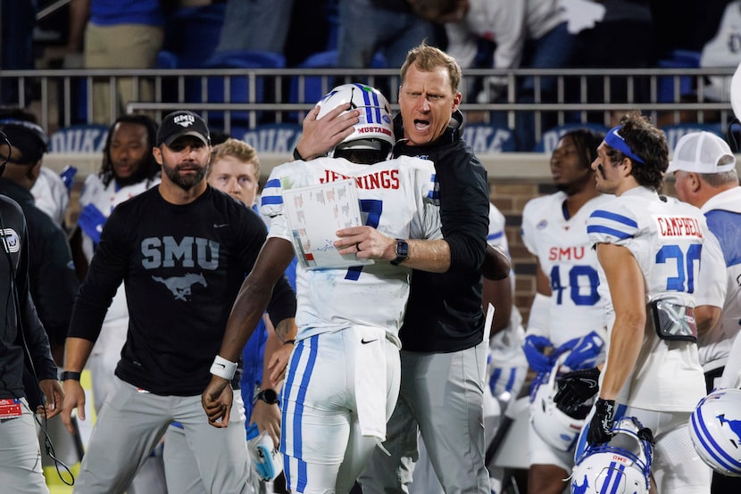 SMU head coach Rhett Lashlee, right, celebrates with quarterback Kevin Jennings (7) after...