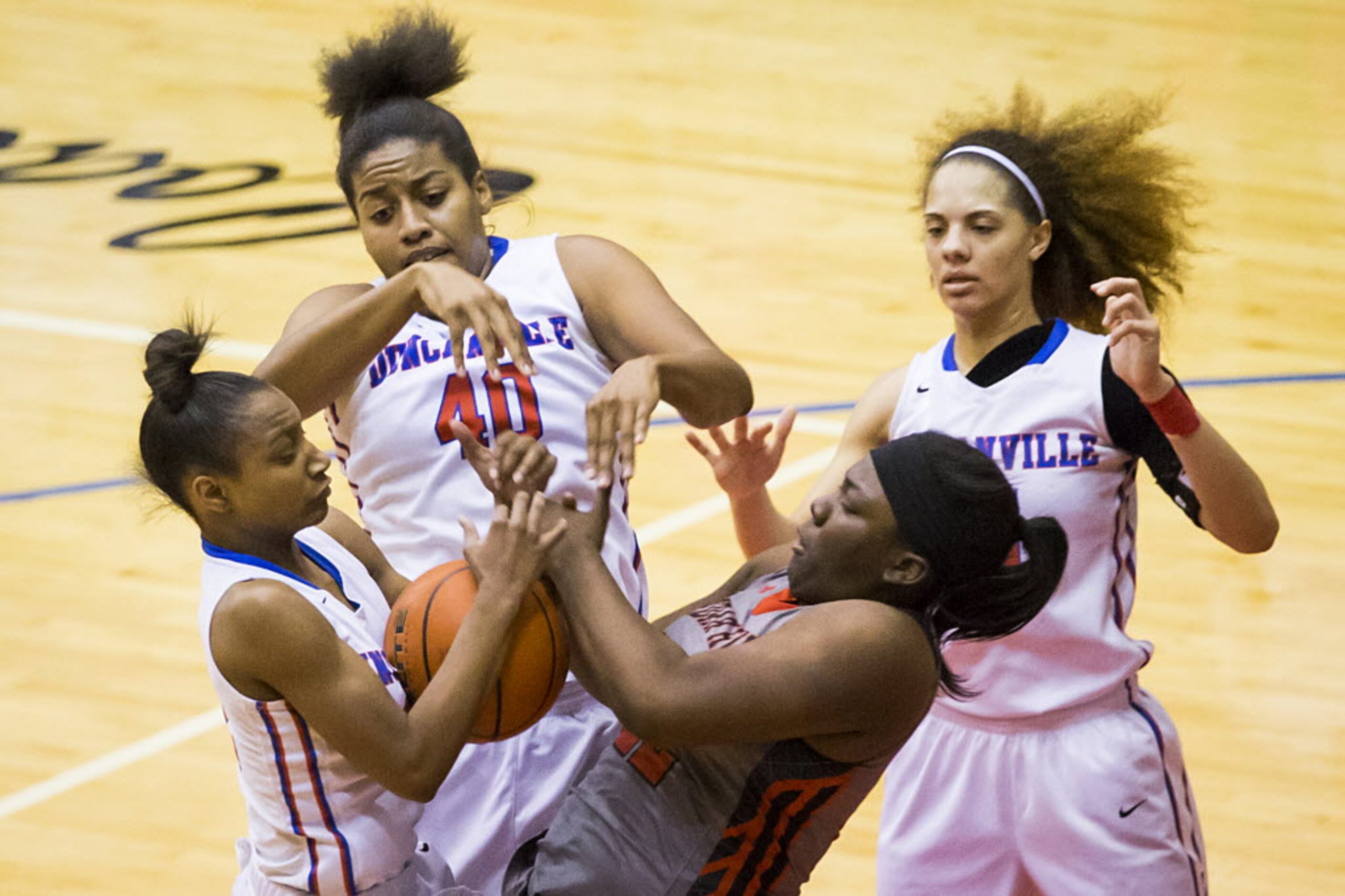 Cedar Hill forward Taylor Hutchins (22) fights for a rebound against Duncanville guard Aniya...