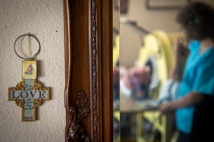 Paul Alexander is reflected in a mirror as he chats with caregiver and friend Kathryn Gaines...