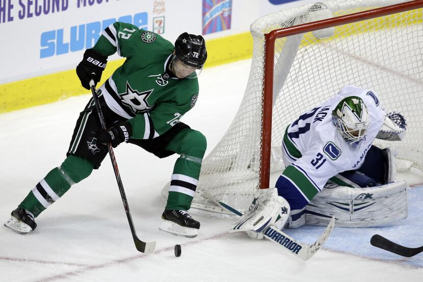 Dallas Stars' Erik Cole (72) prepares for a shot coming around the net against Vancouver...
