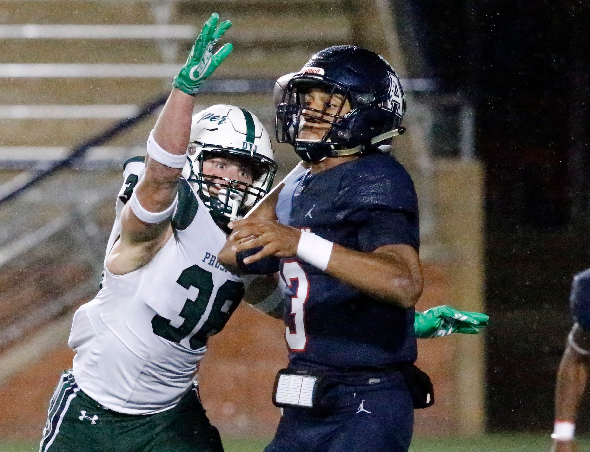 Allen High School quarterback Mike Hawkins (3) makes a throw as he is pressured by Prosper...