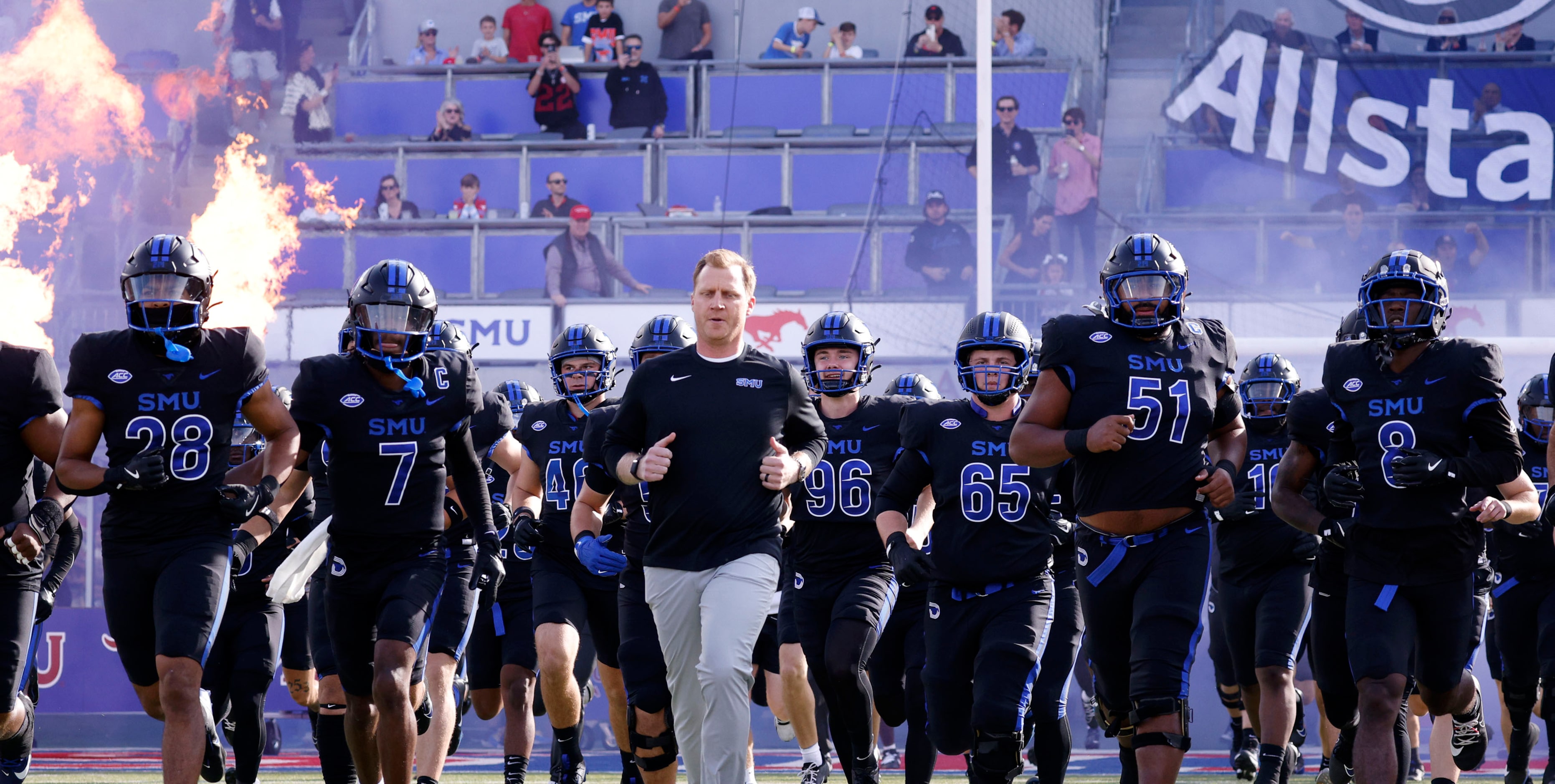 SMU head coach Rhett Lashlee and his players run out to the field before an NCAA college...