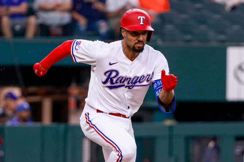 Texas Rangers second baseman Marcus Semien (2) runs towards first during the first inning...