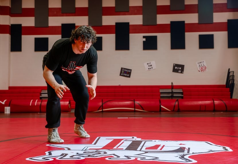 Lovejoy High School wrestler Payton Pierce stands in a starting position on the mat after a...