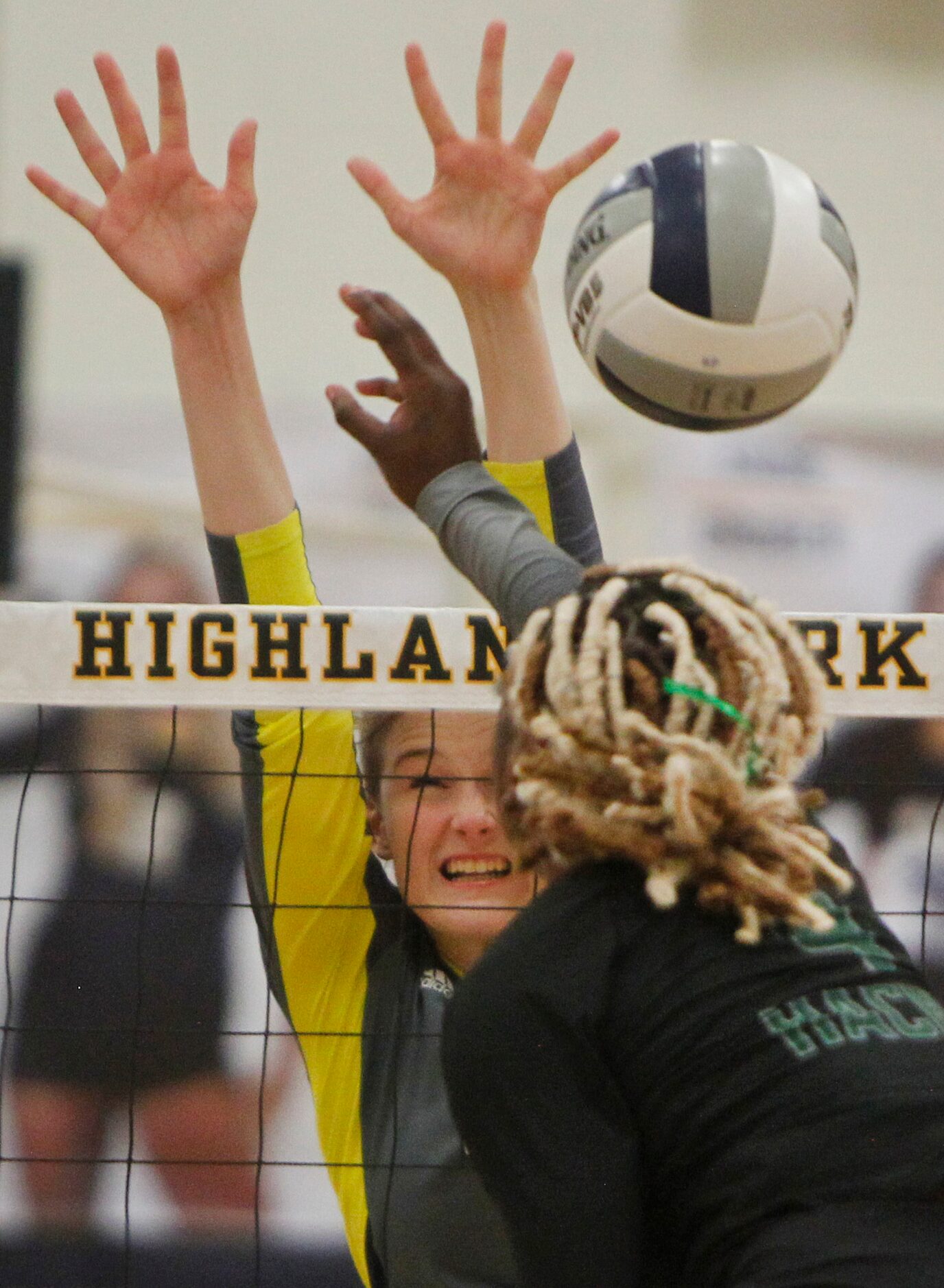 Highland Park outside hitter Emily Hellmuth (19) leaps to block a shot by Waxahachie's Jh'...