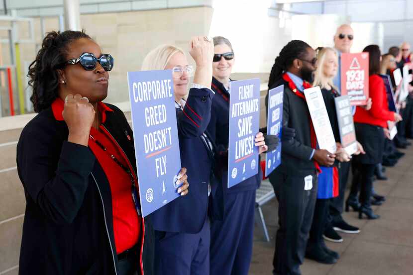 Southwest Airlines flight attendant Cindy Ivy (left) alongside other attendants take part in...
