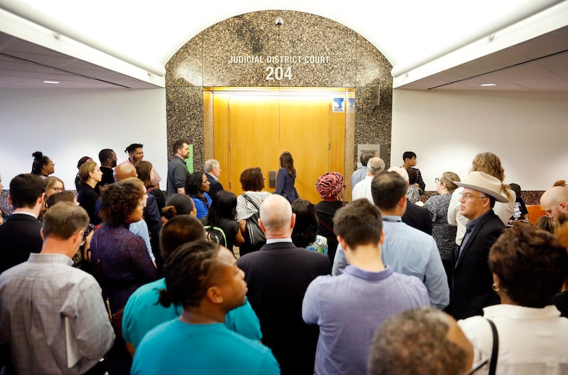 Members of the media wait to get into Judge Tammy Kemp's courtroom for the beginning of the...