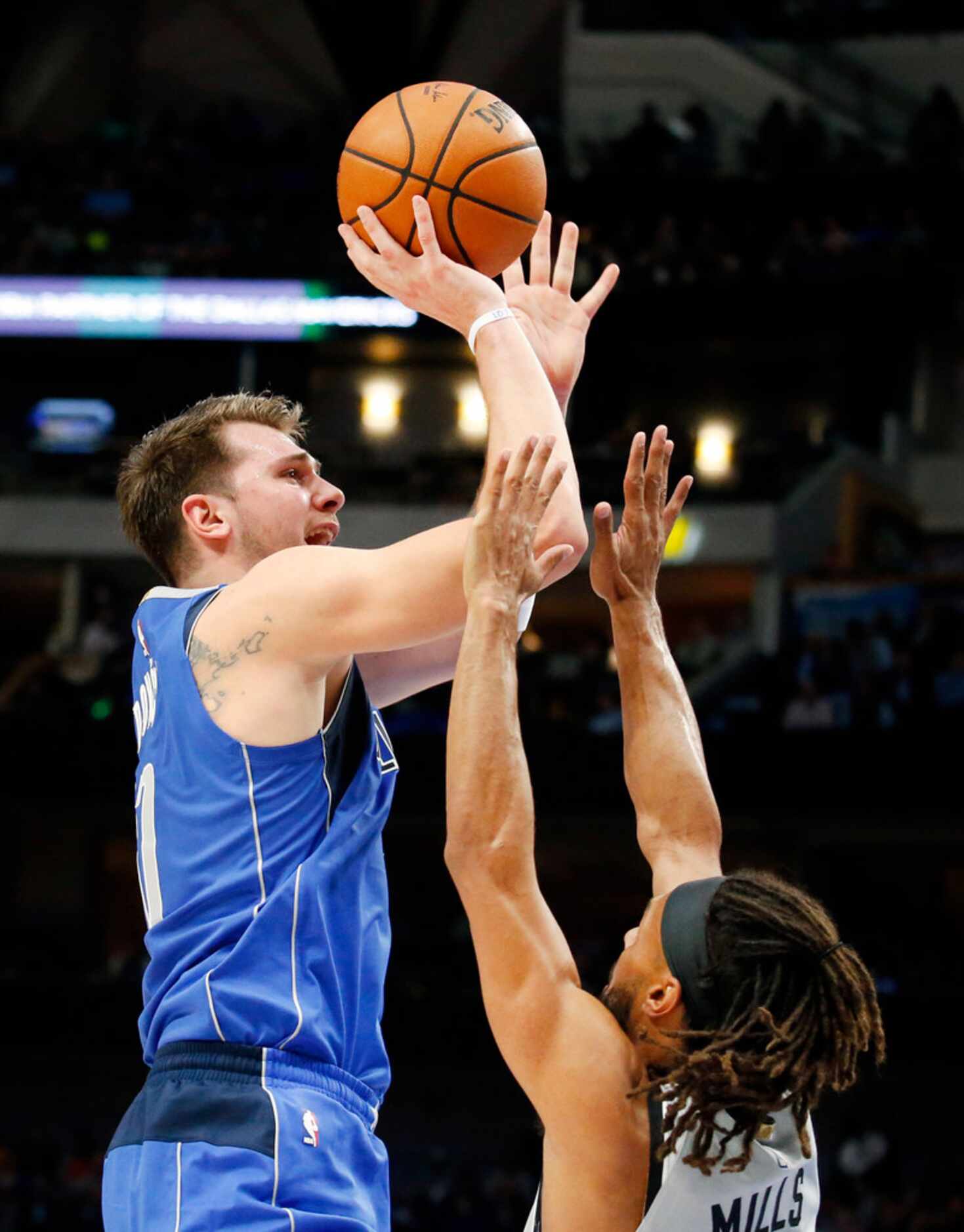 Dallas Mavericks forward Luka Doncic (77) puts up a second quarter shot and is fouled by San...