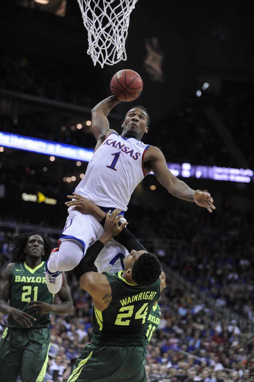Wayne Selden Jr. #1 of the Kansas Jayhawks goes up for a dunk against Ishmail Wainright #24...