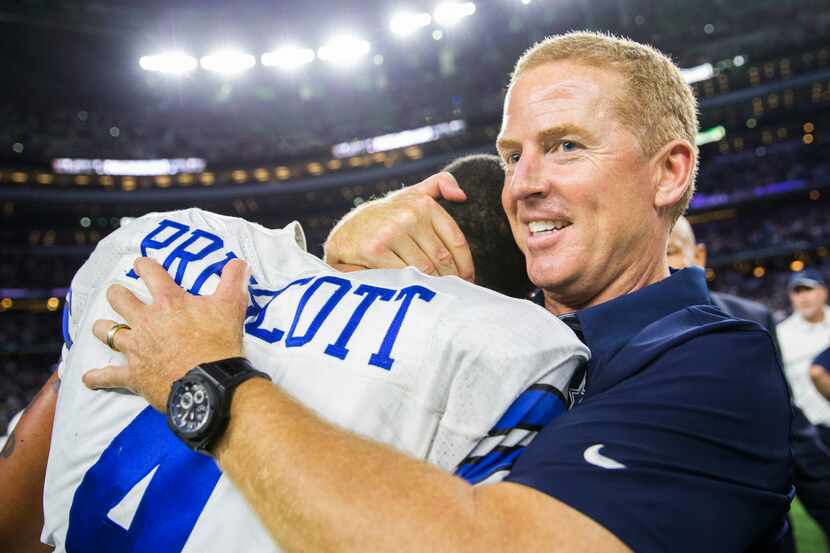 Dallas Cowboys head coach Jason Garrett hugs quarterback Dak Prescott (4) after a 29-23 win...