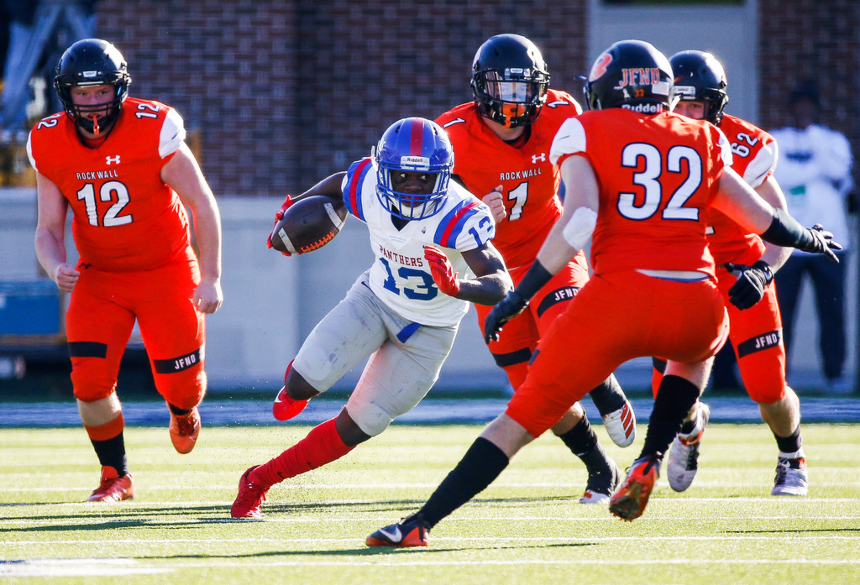 Duncanville wide receiver Roderick Daniels (13) evades a swarm of Rockwall defenders during...