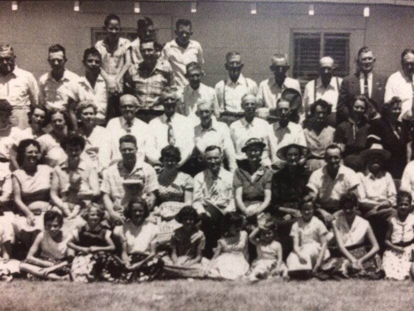 1950's black-and-white photo of rows of people in Sunday clothes