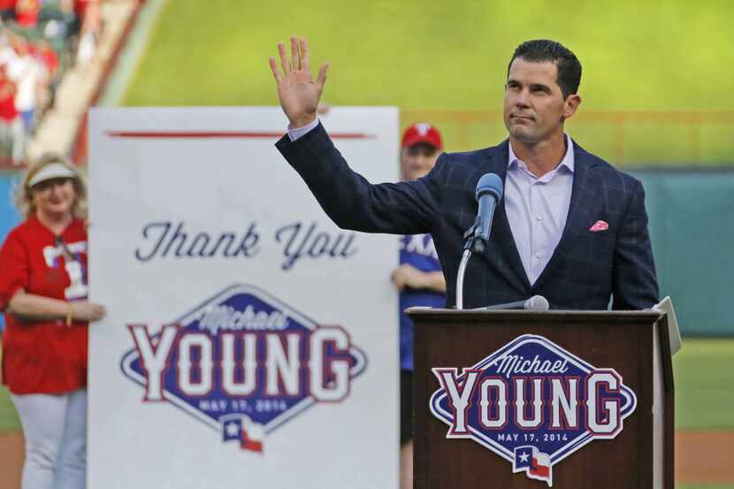 Former Rangers infielder Michael Young acknowledges the cheers of the crowd during a...