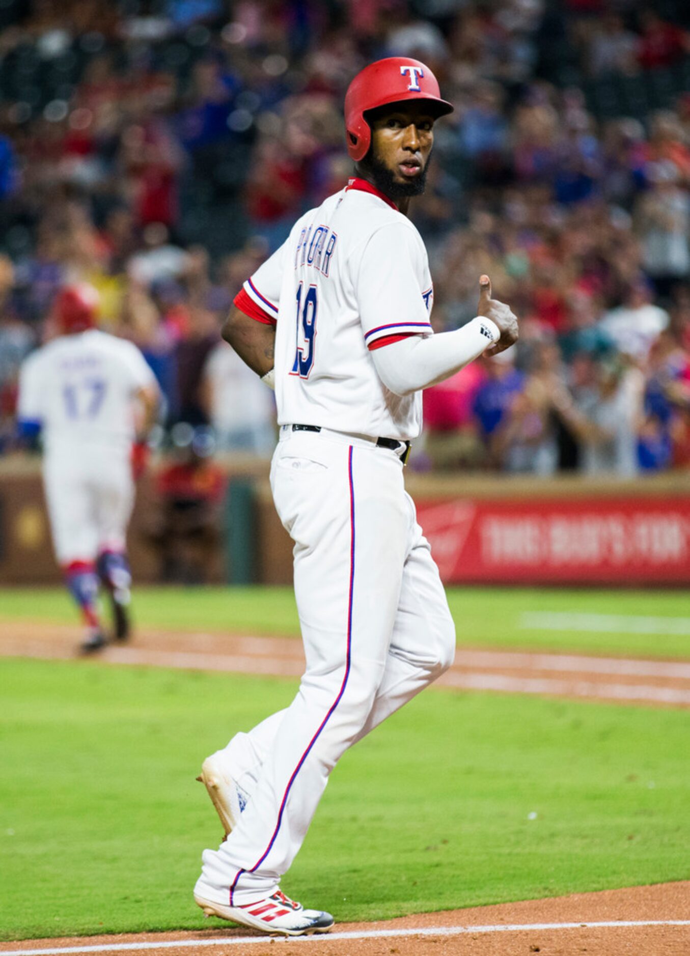 Texas Rangers shortstop Jurickson Profar (19) looks over his shoulder on his way to home...