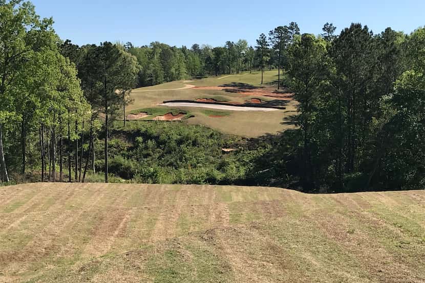 The dramatic par-3 12th's hole at Tempest Golf Club in Gladewater, Texas, requires a shot...