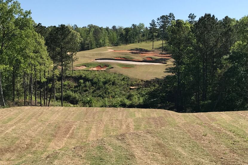 The dramatic par-3 12th's hole at Tempest Golf Club in Gladewater, Texas, requires a shot...