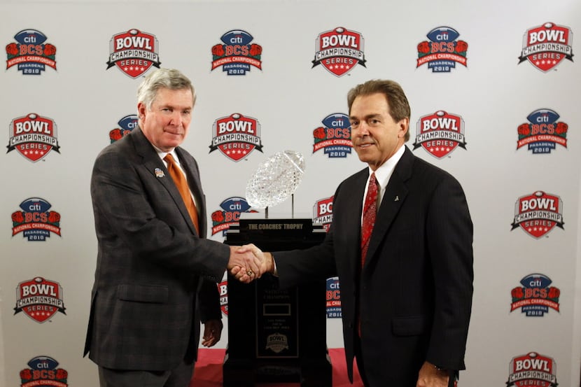 University of Texas' head coach Mack Brown and University of Alabama's Nick Saban shake...