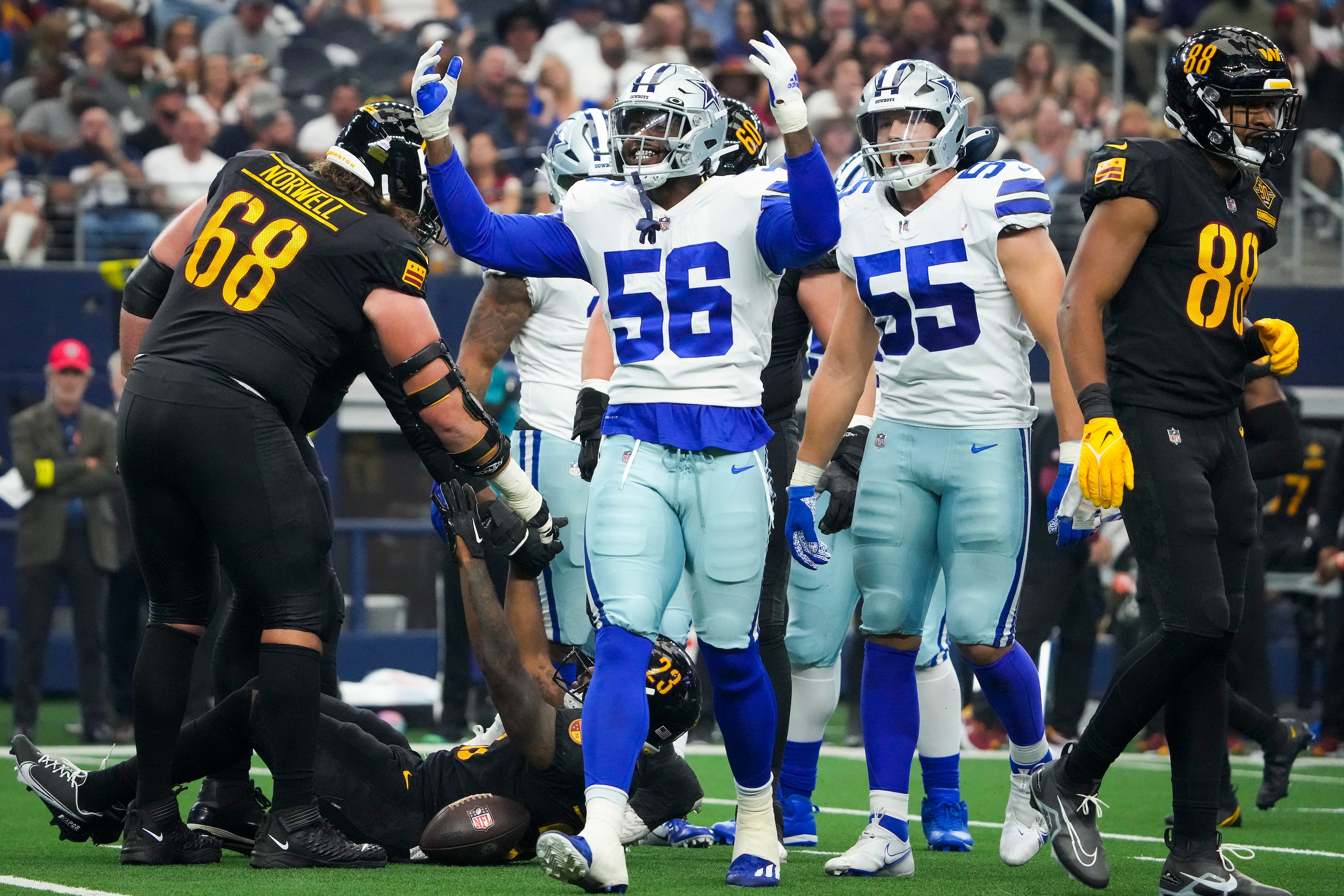 Dallas Cowboys defensive end Dante Fowler Jr. (56) celebrates with linebacker Leighton...