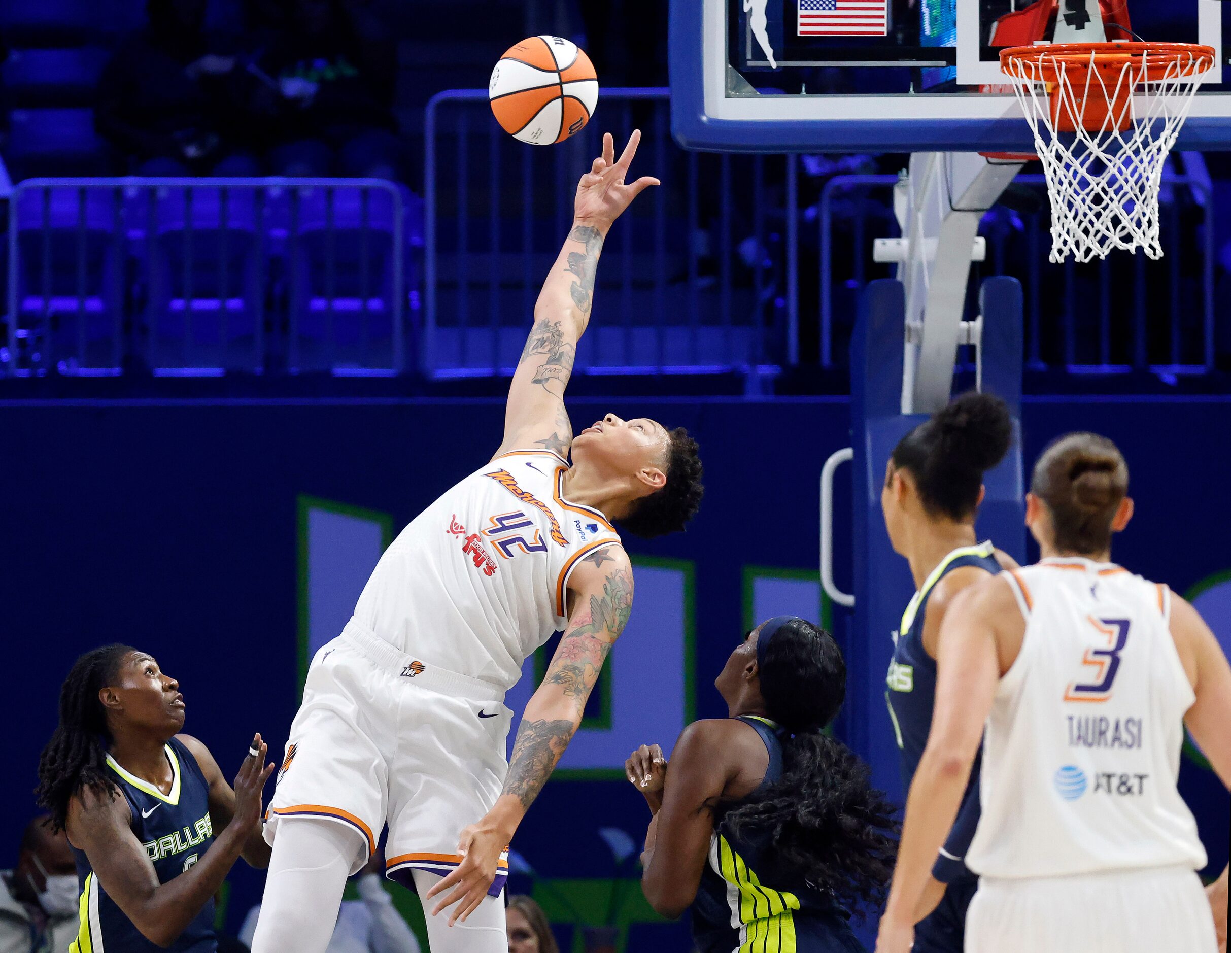 Phoenix Mercury center Brittney Griner (42) skies above Dallas Wings players for a rebound...